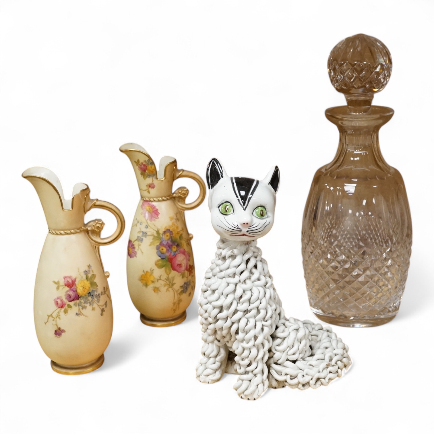 A pair of Worcester blush miniature ewers, an Italian pottery cat and a glass decanter and stopper, decanter 27cm high
